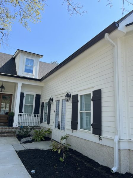 Black gutters with white downspouts - Tri County Guttering Waco, Texas